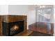 Living room featuring a cozy fireplace, seamlessly connecting to the bright dining area at 3742 S Granby Way, Aurora, CO 80014