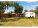 Spacious backyard with a large grassy area and a wood fence providing privacy and security at 5620 E Cornell Ave, Denver, CO 80222