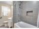 Nicely remodeled bathroom highlighting stylish gray tiling in the shower and a modern sink and vanity at 5620 E Cornell Ave, Denver, CO 80222