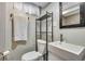 Nicely finished bathroom with a modern vanity and contrasting black shelving unit at 5620 E Cornell Ave, Denver, CO 80222