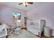 Cozy bedroom with pink walls, white trim, and a comfortable area rug at 5620 E Cornell Ave, Denver, CO 80222