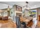 Open floor plan of living room and dining room with hardwood floors and fireplace at 5620 E Cornell Ave, Denver, CO 80222