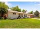 Charming single-story home with a well-manicured lawn and welcoming front entrance at 5620 E Cornell Ave, Denver, CO 80222