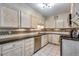 Classic kitchen with ample cabinet space, tile backsplash, and stainless steel appliances at 5620 E Cornell Ave, Denver, CO 80222