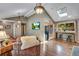 Inviting living room with hardwood floors, a cozy fireplace, and comfortable seating at 5620 E Cornell Ave, Denver, CO 80222