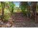 View of a natural area with a stepped trail among trees and vegetation, creating a peaceful outdoor setting at 5620 E Cornell Ave, Denver, CO 80222