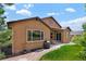 Exterior view of a home with a covered patio and well-manicured lawn at 15616 Soo Line Way, Monument, CO 80132