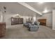 Finished basement with built-in bookshelves, dual recliner, and wood piano at 15616 Soo Line Way, Monument, CO 80132