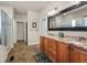 Bathroom features double sinks, granite countertops, and tiled flooring at 15616 Soo Line Way, Monument, CO 80132