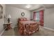 Cozy bedroom featuring a white iron bed frame, floral bedding, and a coordinating window treatment at 15616 Soo Line Way, Monument, CO 80132