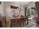 Bright dining area with wood table, decorative rug, and sliding glass doors to the outdoor area at 15616 Soo Line Way, Monument, CO 80132