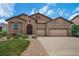 Charming home with a stone and stucco facade, a well-kept lawn, and a three-car garage at 15616 Soo Line Way, Monument, CO 80132
