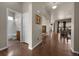 Bright hallway showcasing wood floors, archway, bathroom, and an open entryway to living area at 15616 Soo Line Way, Monument, CO 80132