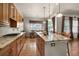 This open kitchen is equipped with granite countertops, wooden cabinetry, and stainless steel appliances at 15616 Soo Line Way, Monument, CO 80132