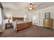 Comfortable main bedroom boasts ceiling fan, plush carpet, and convenient access to an en-suite bathroom at 15616 Soo Line Way, Monument, CO 80132