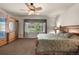 Lovely main bedroom with an armoire, large window, and cozy carpeting at 15616 Soo Line Way, Monument, CO 80132