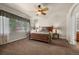 Spacious main bedroom features a ceiling fan, large window, and plush carpeting at 15616 Soo Line Way, Monument, CO 80132