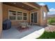 Covered patio featuring an outdoor dining set, grill, and view of the yard at 15616 Soo Line Way, Monument, CO 80132
