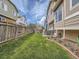 Spacious backyard with lush green grass, wood fence, patio furniture, and brick-lined flowerbeds, perfect for outdoor enjoyment at 16181 White Hawk Dr, Parker, CO 80134