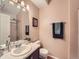 Well-lit bathroom featuring a single vanity, a large mirror, and a shower with glass doors at 16181 White Hawk Dr, Parker, CO 80134