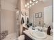 A functional bathroom featuring a tiled shower, a single vanity, and a well-lit mirror at 16181 White Hawk Dr, Parker, CO 80134