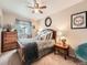 Inviting bedroom with a cozy bed, neutral walls, a ceiling fan, and natural light from the window at 16181 White Hawk Dr, Parker, CO 80134