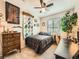 Inviting bedroom boasts natural light, a cozy bed, vintage dresser, and unique decor at 16181 White Hawk Dr, Parker, CO 80134