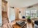 Bright foyer featuring hardwood floors, staircase, a charming welcome wreath and natural light at 16181 White Hawk Dr, Parker, CO 80134