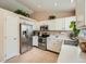 Well-lit kitchen featuring white cabinets, stainless steel appliances, and ample counter space at 16181 White Hawk Dr, Parker, CO 80134