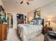 A bright main bedroom showcasing a plush bed with decorative pillows, and warm, neutral walls at 16181 White Hawk Dr, Parker, CO 80134