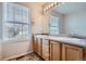 Bathroom features double sinks, wood cabinets and large mirror at 16641 Martingale Dr, Parker, CO 80134