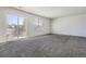 Spacious bedroom with gray carpet and sliding glass door to patio at 16641 Martingale Dr, Parker, CO 80134