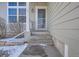 Front entrance with steps leading up to a glass storm door at 16641 Martingale Dr, Parker, CO 80134