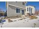 Back of house, patio, and snowy yard at 16641 Martingale Dr, Parker, CO 80134