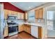 Kitchen with wood cabinets, stainless steel appliances, and white countertops at 16641 Martingale Dr, Parker, CO 80134