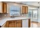 Bright kitchen features wood cabinets, double sink, and dishwasher at 16641 Martingale Dr, Parker, CO 80134