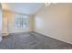 Bright living room with gray carpeting and high ceilings, showcasing a view of the staircase at 16641 Martingale Dr, Parker, CO 80134
