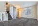 Spacious living room with gray carpeting, neutral walls, and ample natural light at 16641 Martingale Dr, Parker, CO 80134