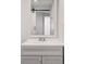 Stylish bathroom vanity with a sliding barn door and modern fixtures at 8826 E Florida Ave # G11, Denver, CO 80247
