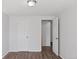 Neutral-colored bedroom with wood floors, white trim and doors, and closet access at 8826 E Florida Ave # G11, Denver, CO 80247