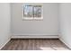 An empty bedroom with hardwood flooring and a window overlooking the outdoors at 8826 E Florida Ave # G11, Denver, CO 80247