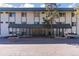 Front view of the building with a covered entrance featuring an awning and landscaped surroundings at 8826 E Florida Ave # G11, Denver, CO 80247