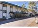 Exterior building view showcases architecture, greenery, and a covered walkway in a well-maintained setting at 8826 E Florida Ave # G11, Denver, CO 80247