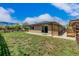 Beautiful backyard with lush green grass, patio, full fence, and access to the sliding glass door at 710 4Th St, Bennett, CO 80102