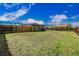 Large back yard showcasing a well-maintained lawn and a sturdy wooden fence for privacy at 710 4Th St, Bennett, CO 80102
