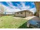 The backyard has a grassy area, partial fence, and a patio space, perfect for entertaining at 710 4Th St, Bennett, CO 80102
