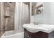 Bathroom featuring a shower-tub combo, vanity with sink, and large mirror at 710 4Th St, Bennett, CO 80102