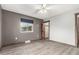 Bright bedroom showcasing neutral walls, ceiling fan, hardwood floors, and closet access at 710 4Th St, Bennett, CO 80102