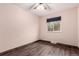 Bedroom with a window and wood-look flooring and baseboards at 710 4Th St, Bennett, CO 80102