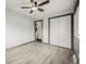 Bedroom with wood trim, closet and natural light streaming through the window at 710 4Th St, Bennett, CO 80102